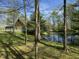 Scenic view of the property highlighting a tranquil pond reflecting the surrounding trees and greenery at 1340 Apache Trl, Martinsville, IN 46151