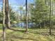 Scenic view of the property highlighting a tranquil pond reflecting the surrounding trees and greenery at 1340 Apache Trl, Martinsville, IN 46151
