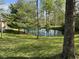 Scenic view of the property highlighting a tranquil pond reflecting the surrounding trees and greenery at 1340 Apache Trl, Martinsville, IN 46151