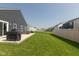 Spacious backyard with green lawn, patio area, and privacy fence; perfect for outdoor living at 1483 Paper Birch Dr, Sheridan, IN 46069