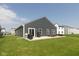Expansive backyard features a patio, grill, and plenty of green space for outdoor activities and enjoyment at 1483 Paper Birch Dr, Sheridan, IN 46069