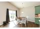 Cozy dining area with a round table and chairs next to sliding glass doors at 1483 Paper Birch Dr, Sheridan, IN 46069