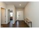 Bright entryway with hardwood floors, a console table and a view into the carpeted bedroom at 1483 Paper Birch Dr, Sheridan, IN 46069