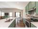 Beautiful kitchen featuring green cabinets, stainless steel appliances, and an island with a sink at 1483 Paper Birch Dr, Sheridan, IN 46069