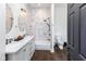 Modern bathroom features a double sink vanity, a marble-tiled wall, and a shower and bath at 1730 Hoyt Ave, Indianapolis, IN 46203