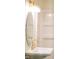 Bathroom featuring a gold faucet, oval mirror, and bright lighting at 1730 Hoyt Ave, Indianapolis, IN 46203