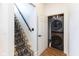 Hallway and stairs of a home with black metal railings adjacent to a laundry area at 1730 Hoyt Ave, Indianapolis, IN 46203