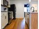 Charming kitchen with stainless steel appliances, a modern island, and hardwood floors at 1730 Hoyt Ave, Indianapolis, IN 46203