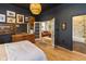 Relaxing bedroom with hardwood floors, stylish decor, and an open doorway to the home's living room at 1730 Hoyt Ave, Indianapolis, IN 46203