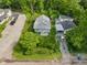 Charming home with a large yard and mature trees, as seen from an aerial view at 1802 E 66Th St, Indianapolis, IN 46220