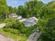 Aerial view of a charming home with a well-maintained yard, surrounded by lush greenery and mature trees at 1802 E 66Th St, Indianapolis, IN 46220