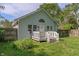 Charming light-blue home with a well-manicured lawn, a small deck, and a surrounding wooden fence at 1802 E 66Th St, Indianapolis, IN 46220