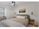 Calm bedroom with a ceiling fan, ambient sconces and neutral decor provides a relaxing retreat at 1802 E 66Th St, Indianapolis, IN 46220