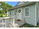 Inviting front porch with a welcoming wreath adorning the front door at 1802 E 66Th St, Indianapolis, IN 46220