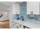 Bright kitchen featuring quartz countertops and a stylish blue tile backsplash at 1802 E 66Th St, Indianapolis, IN 46220