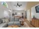 Bright living space features a large sofa, vaulted ceiling and views to dining and kitchen areas at 1802 E 66Th St, Indianapolis, IN 46220
