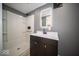 Nicely updated bathroom with shower and a brightly lit mirror at 1808 Raible Ave, Anderson, IN 46011