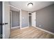 Cozy bedroom featuring wood-look floors, gray walls, closet, and doorway to other rooms at 1808 Raible Ave, Anderson, IN 46011