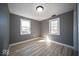 Charming bedroom showcasing two windows that bring in natural light and light-colored floors at 1808 Raible Ave, Anderson, IN 46011