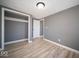 Bedroom featuring modern flooring, gray walls, a closet, and a bright source of natural light at 1808 Raible Ave, Anderson, IN 46011