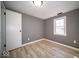 Well-lit bedroom with wood-look flooring, gray walls, and a window providing natural light at 1808 Raible Ave, Anderson, IN 46011