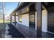 Close-up of the front porch of a two-story home featuring black trim and front door at 1808 Raible Ave, Anderson, IN 46011