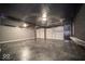 Spacious garage with epoxy flooring, garage door, and lighting fixtures for convenience and security at 1808 Raible Ave, Anderson, IN 46011