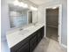Elegant bathroom with double sinks, quartz countertops, and a glass-enclosed shower at 18230 Sandy Cove Ln, Westfield, IN 46074