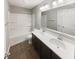 Bathroom featuring double sinks, quartz countertops, and a shower-tub combination at 18230 Sandy Cove Ln, Westfield, IN 46074