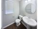 Charming half-bath with pedestal sink, round mirror, and modern fixtures at 18230 Sandy Cove Ln, Westfield, IN 46074