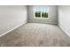 Bright bedroom featuring neutral carpeting and a window offering serene outdoor views at 18230 Sandy Cove Ln, Westfield, IN 46074