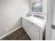 Functional laundry room with modern washer and dryer units and stylish flooring at 18230 Sandy Cove Ln, Westfield, IN 46074
