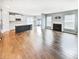 Open-concept living space with hardwood floors, a kitchen, and a fireplace at 18230 Sandy Cove Ln, Westfield, IN 46074