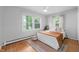 Inviting bedroom with soft lighting, hardwood floors, and comfortable furnishings at 2120 Wynnedale Rd, Indianapolis, IN 46228