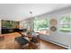 Bright and airy dining area with a large window offering scenic views, complemented by a modern light fixture at 2120 Wynnedale Rd, Indianapolis, IN 46228