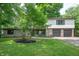 Charming two-story home featuring a stone facade and a well-maintained front yard with mature trees at 2120 Wynnedale Rd, Indianapolis, IN 46228