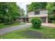 Charming two-story home with stone facade, two-car garage, and mature landscaping at 2120 Wynnedale Rd, Indianapolis, IN 46228