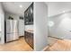 Kitchen with stainless steel refrigerator, custom cabinetry and beautiful hardwood floors at 2120 Wynnedale Rd, Indianapolis, IN 46228