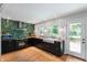 Stunning kitchen featuring a black oven, sleek countertops, and vibrant green backsplash at 2120 Wynnedale Rd, Indianapolis, IN 46228
