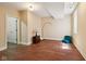 Spacious room with hardwood floors and neutral colored walls featuring a door and a window at 2191 Greencroft St, Carmel, IN 46032