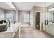 Bathroom features white cabinets, soaking tub with tile surround, and neutral paint at 2191 Greencroft St, Carmel, IN 46032