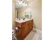 Bathroom featuring a wood vanity, a sink, a mirror, a toilet, and neutral paint and decor at 2191 Greencroft St, Carmel, IN 46032