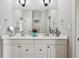 Bright bathroom featuring a double sink vanity, large mirror and modern fixtures at 2191 Greencroft St, Carmel, IN 46032