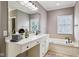 Bathroom with white cabinets, neutral paint and large soaking tub at 2191 Greencroft St, Carmel, IN 46032