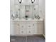 Bathroom with a double sink vanity, with modern fixtures and gray patterned rug at 2191 Greencroft St, Carmel, IN 46032
