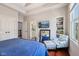 Bedroom with an accent chair and ottoman, hardwood floors, flat screen TV, and built-in bookcase at 2191 Greencroft St, Carmel, IN 46032