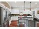 Modern kitchen with stainless steel appliances, a black island, and white cabinets at 2191 Greencroft St, Carmel, IN 46032