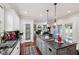 Bright kitchen with an island cooktop, granite countertops, and seamless access to the living area at 2191 Greencroft St, Carmel, IN 46032