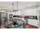 Modern kitchen with stainless steel appliances, a black island, and white cabinets at 2191 Greencroft St, Carmel, IN 46032