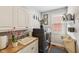 Well-lit laundry room with washer/dryer, sink and overhead cabinets at 2191 Greencroft St, Carmel, IN 46032